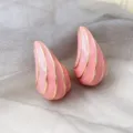 Close-up detail of pink enamel teardrop earrings featuring elegant gold geometric line accents. - Pink