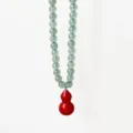 Green aventurine bead necklace detail with vibrant red gourd pendant, elegant close-up view. - Necklace (5.22-2) / 8mm Bead Necklace / Green