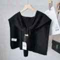 Detail shot of black knitted shawl with tie design, versatile layered shoulder accessory. - Black Striped Shawl with Wool