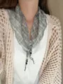 Close-up detail of a French style plaid triangular neckerchief with delicate beaded tassels. - Color 7
