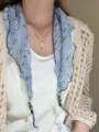 Close-up of lightweight floral print neck scarf with beaded ends, elegant styling detail. - Color 11