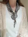 Detailed shot of a Korean style leopard print triangle scarf with chic beaded charm ties. - Color #17