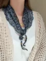 Close-up detail shot of the chic floral triangular scarf with delicate beaded strings. - Color #19