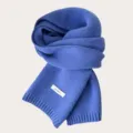 Detailed view of the cozy blue winter knit wool scarf, showing soft texture and wool material label. - Poggio Blue