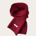 Detailed view of the dark red knitted wool scarf, showcasing fine texture and soft material. - Ancorra Red