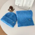 Detailed close-up of the soft fuzzy blue knit beanie hat and cozy matching winter scarf set. - Blue