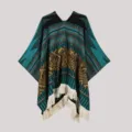 Detailed view of bohemian tribal knitted poncho with ethnic geometric patterns and fringe. - Pullover Shawl in Blue