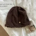 Detailed view of women's brown cable knit woolen beanie, showing soft winter warm texture. - M (56-58cm) / Coffee