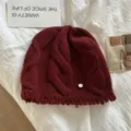 Close-up view of the cozy wool cable knit beanie hat texture in burgundy winter style. - M (56-58cm) / Red