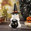 Detailed macro view of a Halloween resin ghost figurine with a witch hat and cauldron - Holding Cauldron Style / Ghost With Black Hat