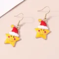 Dettaglio macro di graziosi orecchini a stella con festosi cappelli rossi di Babbo Natale - Stella di Natale Sorridente