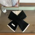 Nahaufnahme des schwarz-weißen Wollschals mit feinen Kantenstichen und weicher Textur. - Schwarz