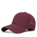 Close-up detail of the breathable mesh perforated quick-drying sports baseball cap fabric. - Burgundy