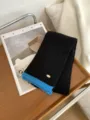 Gemütlicher schwarzer Strickschal für den Winter mit blauen Akzenten und Metall-Logo. - Schwarz Blauer Rand