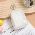 Mini translucent white backpack shaped coin purse featuring cute daisy print and metal keychain ring. - Style 3