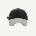 Vista detallada de la gorra bicolor en negro y beige, mostrando las costuras de la visera. - M (56-58cm) / Negro