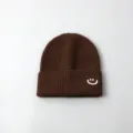 Brown knitted winter beanie for kids with cute white embroidered smiley face variant. - Hat / Coffee