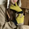 Close-up view of cozy knit colorblock gloves in olive green and black, warm winter wear detail. - One Size / Lemon Yellow