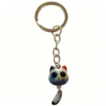 Cute calico cat keychain with big eyes and movable tail, stylish metal bag charm pendant. - Blue and Gray Heterochromia