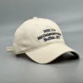 Vue rapprochée détaillée de la casquette en coton beige avec broderie sur le devant. - Réglable / Blanc Cassé