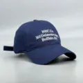 Vue détaillée de la casquette de baseball bleu foncé avec broderie blanche et adresse. - Réglable / Bleu marine