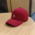 Red baseball cap detail view, featuring white embroidered R letter and neat brim stitching. - M (56-58cm) / Burgundy