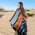 Detail view of the autumn winter ethnic style colorblock split cloak shawl for women warm cashmere feel. - Large Striped Orange & Navy Blue