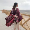Outdoor scene detail of women ethnic style woolen cloak, showcasing split design and pattern. - Tulip Burgundy