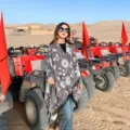 Floral pattern tassel cape detail view in outdoor desert travel setting, autumn warm shawl. - Ethnic Floral Grey