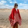 Detail shot of women's red houndstooth knit cape shawl, stylish winter warm outdoor poncho. - Double-Ended Houndstooth Red
