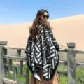 Detail view of a black and white geometric patterned winter poncho shawl for women outdoor travel - Black & White Triangles