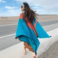 Detail view of women's ethnic cashmere-feel color-blocked fringe cape shawl for autumn and winter. - Potala Palace Blue