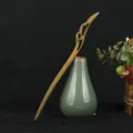 Detailed close-up view of the green sandalwood wooden hairpin in an ancient Chinese style. - Xianyu Style