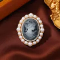 Vintage oval cameo brooch featuring pearl rim and rhinestone accents for chic coat decoration. - Gray