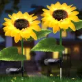Close-up detail of glowing solar sunflower garden lights illuminating outdoor lawn at dusk. - Single Head Sunflower