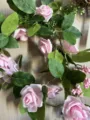 Gros plan détaillé de la guirlande de fleurs de roses roses artificielles avec LED. - Rose Rose