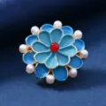 Close-up detail shot of the vintage enamel flower brooch with pearls and red center bead. - Bead Daisy Style / Blue