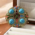 Retro Chinese style turquoise brooch with colorful enamel floral details for qipao and hanfu. - Round Shield with Four Turquoises