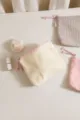 Close-up detail of corduroy cosmetic bag with zipper and cute rope pull, perfect travel storage. - Off White