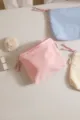Corduroy cosmetic bag detail, soft fabric texture with zipper pull and side label storage. - Pink