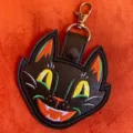 Close-up detail of Halloween cat PU leather keychain, embroidered cute pendant for bags. - Kitten
