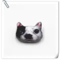 Close-up detail of the 3D cartoon dog head plush brooch, cute animal badge and accessory. - New French Bulldog