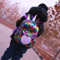 Details of the cute unicorn sequin backpack showing its vibrant rainbow colors and horn design. - L / Multi-color
