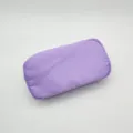 Purple nylon cosmetic bag detail view, displaying smooth fabric texture and simple shape. - Purple