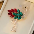 Close up detail of sparkling rhinestone flamingo brooch with red and green crystal feathers. - 60*40mm / Dark Green Red
