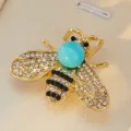 Ajoutez une touche d'élégance avec cette broche abeille en strass pour costume. - Base Bronze Bleu