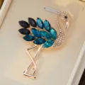 Gros plan d'une broche flamant rose en strass avec cristaux bleus et alliage doré scintillant. - 60*40mm / Bleu Encre