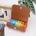 Portable 7-day pill organizer with brown PU leather case, weekly vitamin storage box. - Brown + Multicolor Box