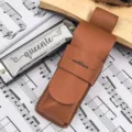 Detailed close-up of brown PU leather harmonica protective case with custom engraved name tag. - No Logo / 1 Piece / Brown