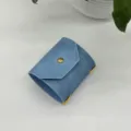 Blue leather cash wrap wallet with snap button and yellow elastic band for daily storage. - Blue